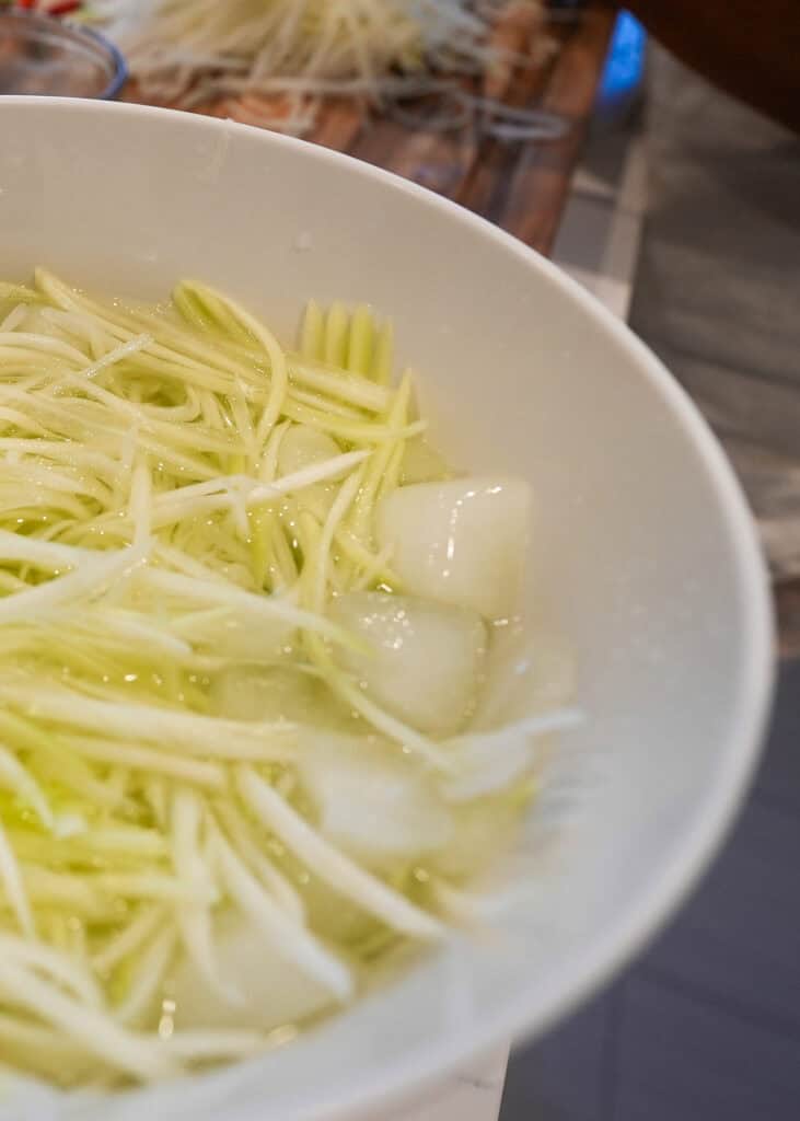 Shredded papaya in iced water for crispy papaya