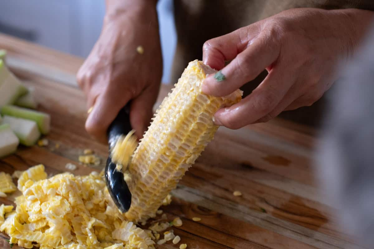 Peeling corn from cob with peeler