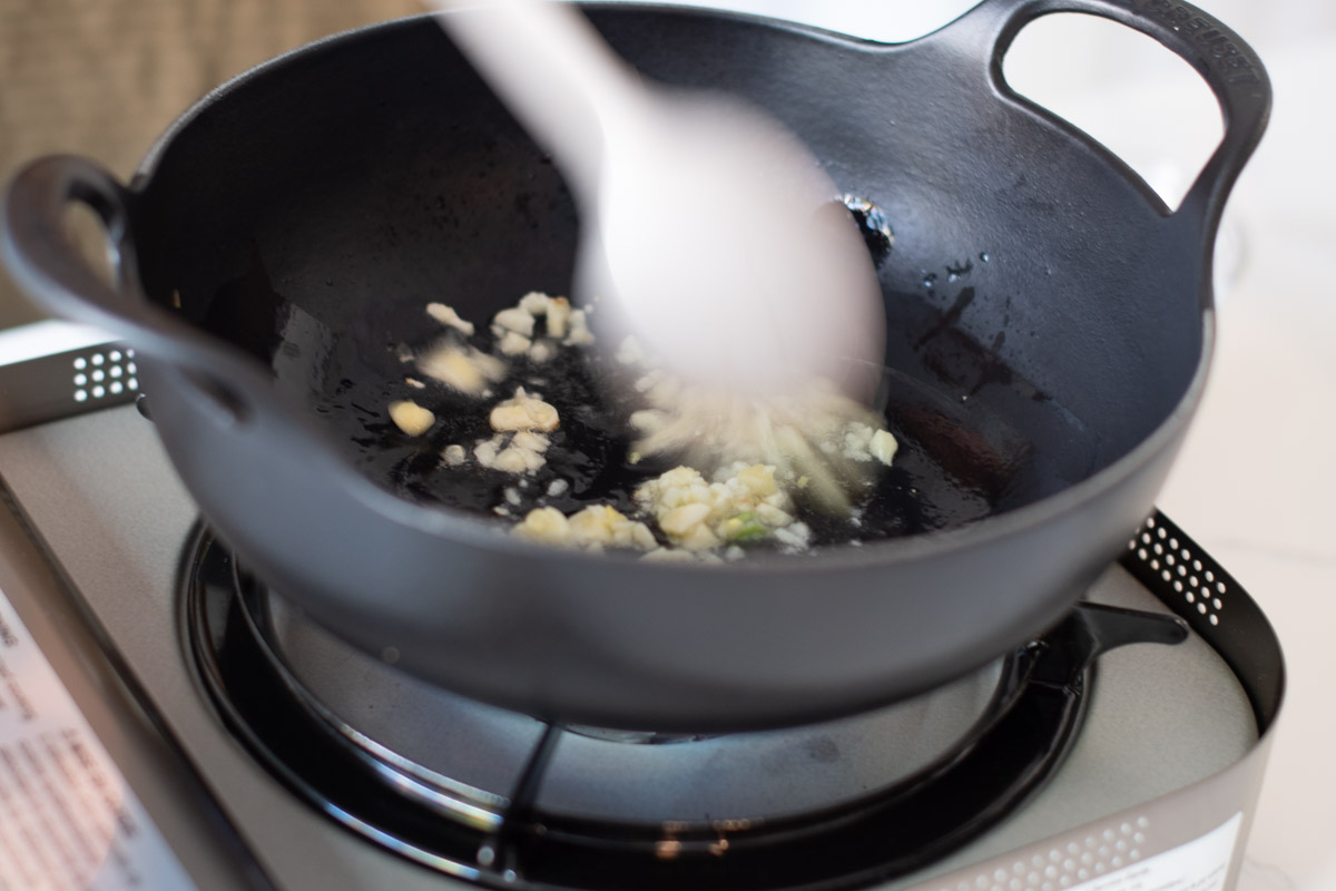 Add oil and brown garlic in wok at medium heat
