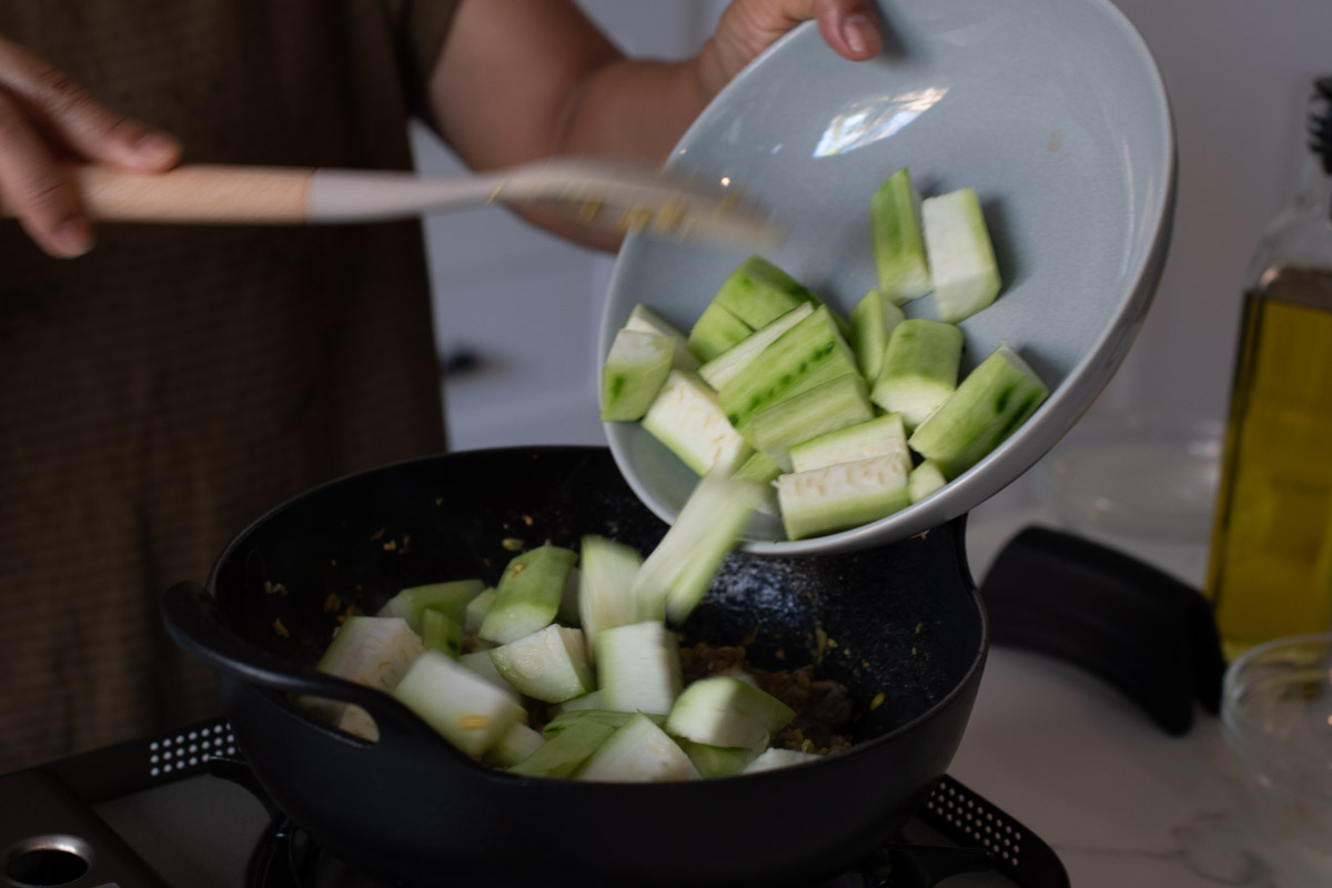 Adding the chinese okra to the stew.
