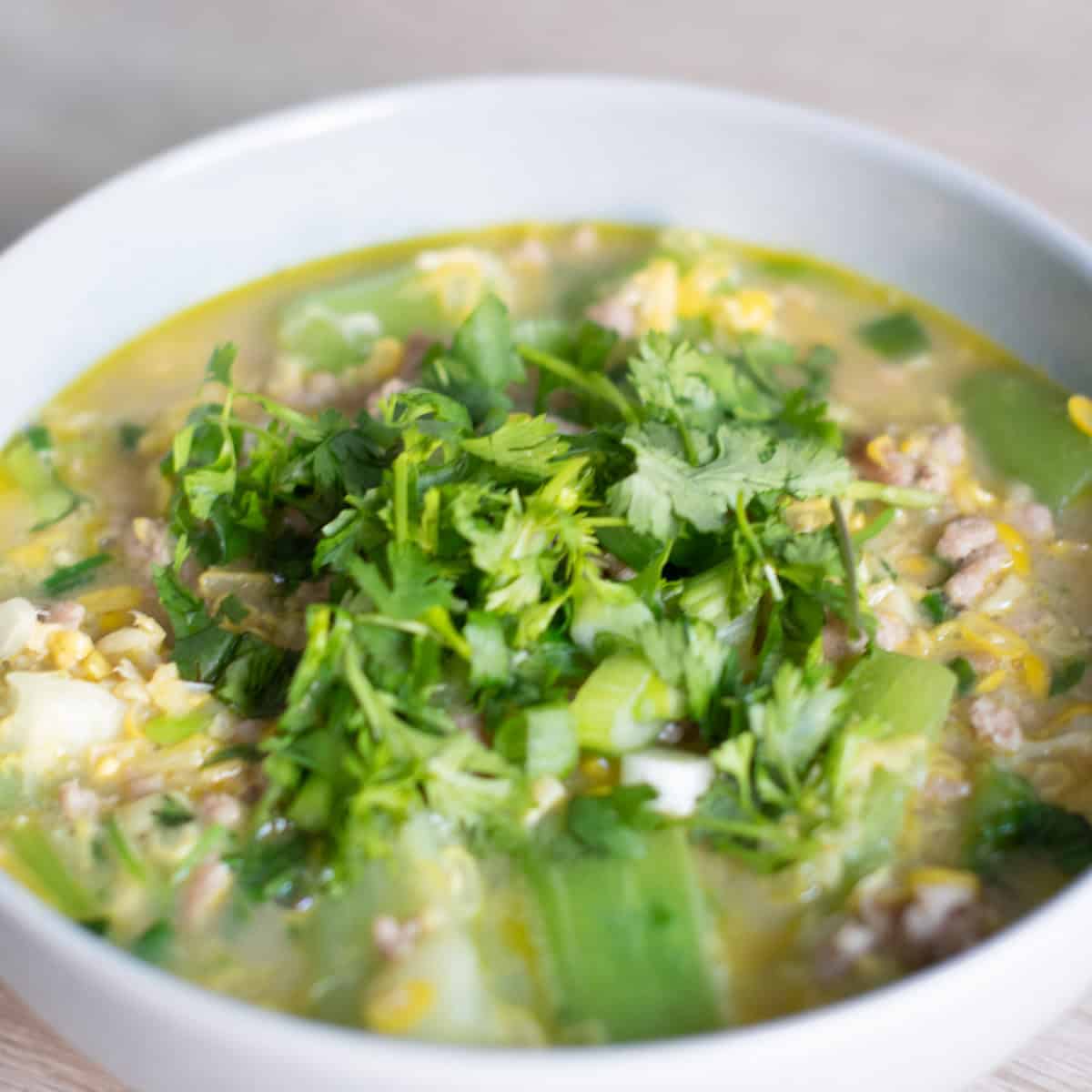 Cambodian Okra and Corn Stew served in a grey bowl garnished with cilantro