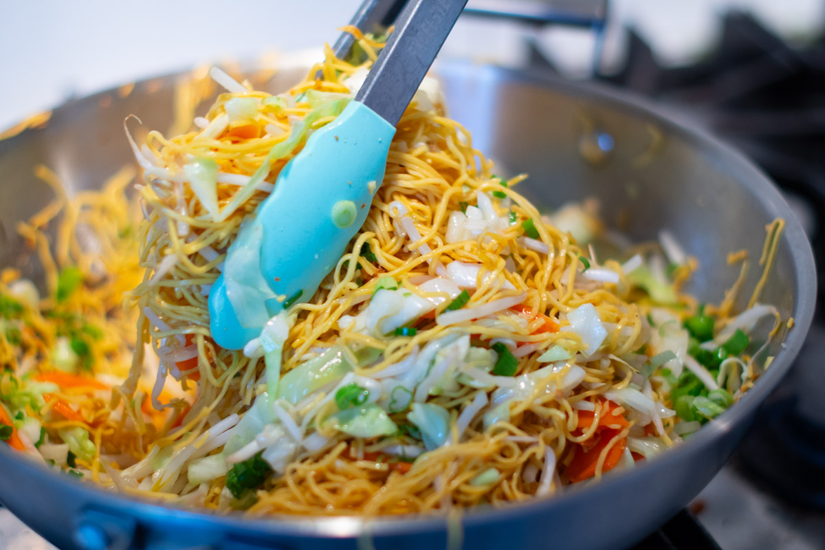 Final tossing of chow mein noodles and vegetables for Vegetarian Cambodian Mee Cha Jay.